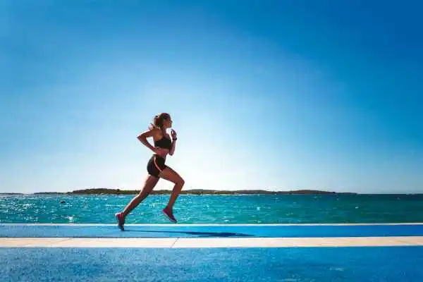 Woman running showing strong leg muscle Yeovil
